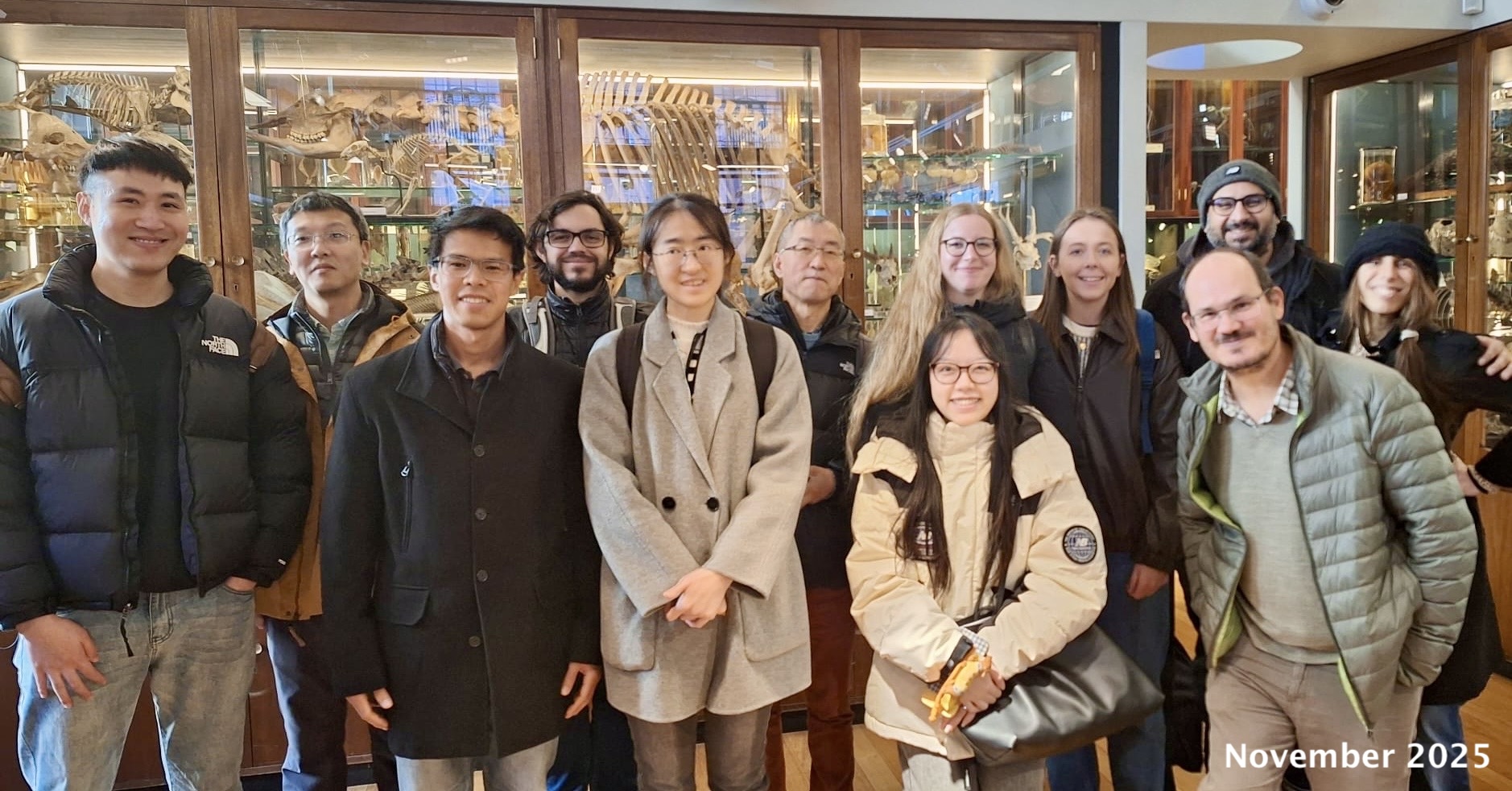 dos Reis and Yang labs at the Grant Museum, UCL, November 2025. Left to right: Jiayi Ji, Chi Zhang, Yuttapong Thawornwattana, Lucas Freitas, Zihui Yang, Ziheng Yang, Yuqing Peng (bottom), Siri Olsen (top), Laura Mulvey, Mario dos Reis (bottom), Asif Tamuri (top), Sandra Álvarez-Carretero.